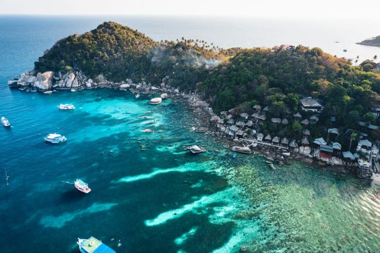 Island and boat in clear sea at Koh Tao