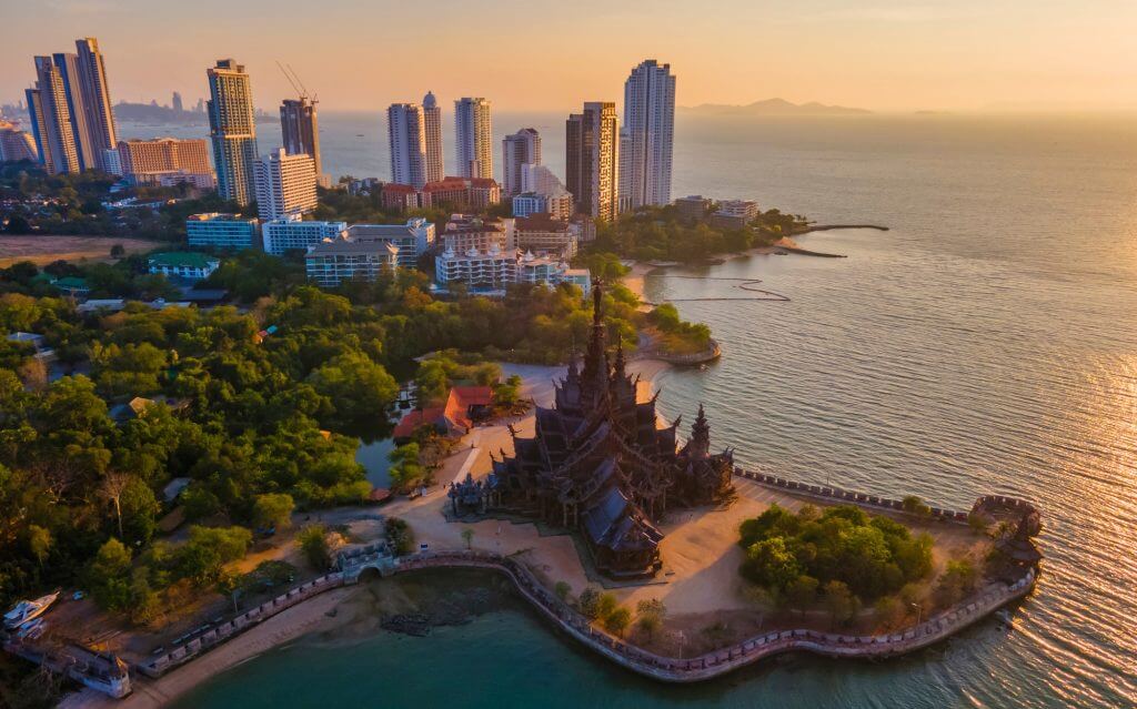 Sanctuary of Truth, Pattaya, Thailand, wooden temple by the ocean at sunset on the beach of Pattaya